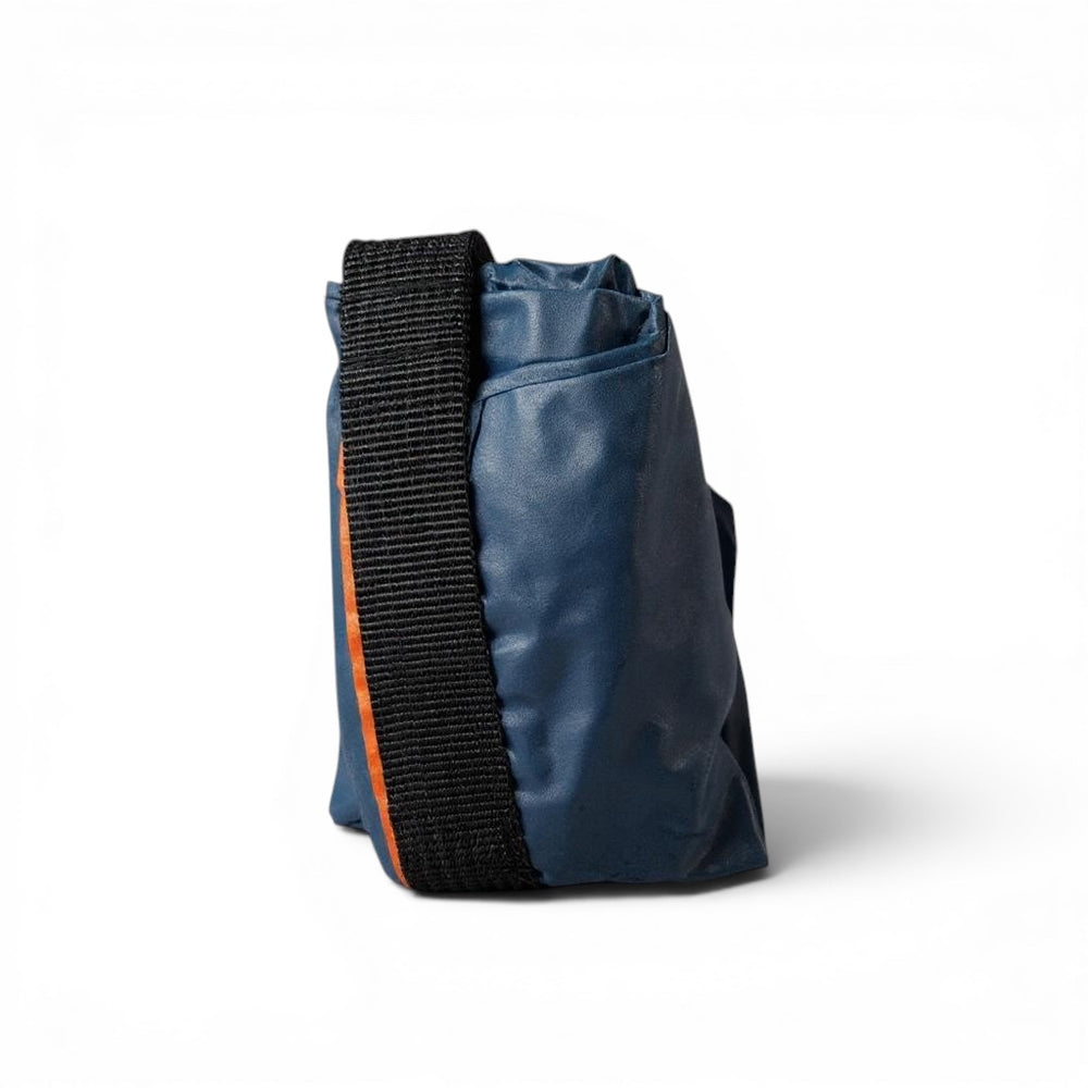 Think4Earth blue reusable baguette bag made from rPET with black strap and orange trim, rolled for storage.