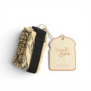 Think4Earth reusable baguette bag in tan with black line art print. Made from rPET, it features a roll-and-clip closure and is freezer safe.