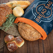 Think4Earth reusable bread bag in navy blue with orange trim, made from recycled plastic bottles, holding a loaf of bread.