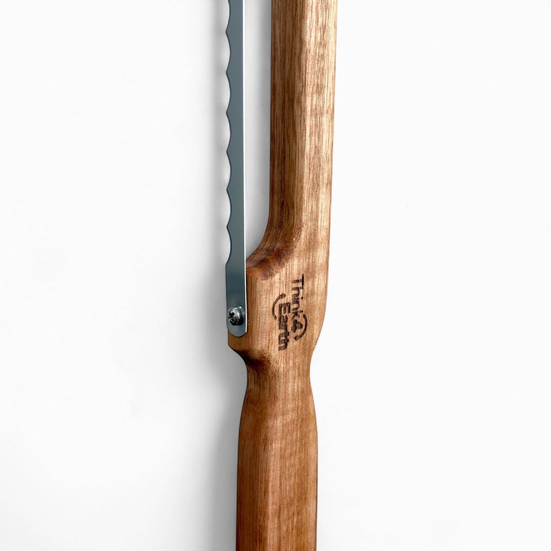 Think4Earth Tasmanian Oak bread saw with stainless steel serrated blade, fixed for toast thickness.